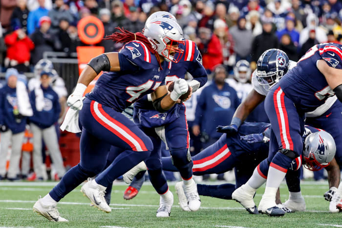 Jakob Johnson runs toward the line of scrimmage to deliver a block during a game against the Titans
